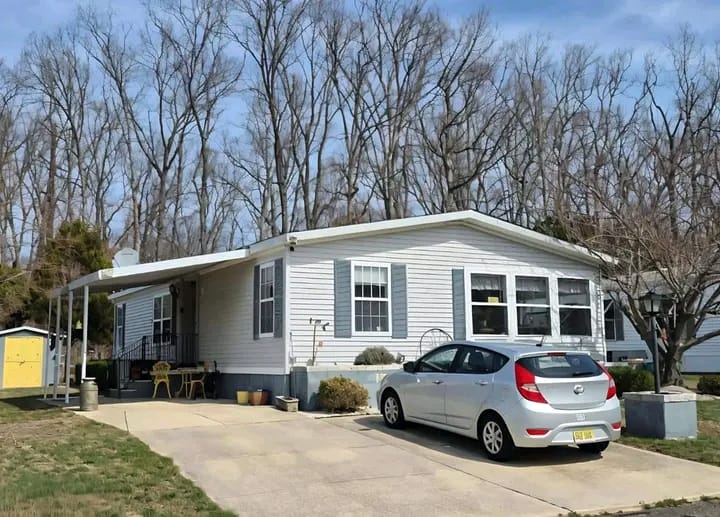 A beautiful house with a green lawn and trees around it